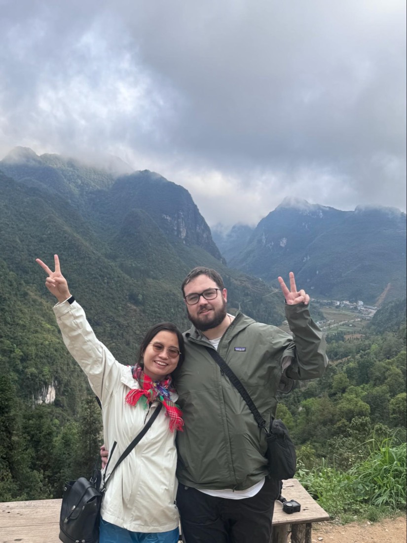 Trang and Robert in front of the misty mountains of the Ha Giang loop
